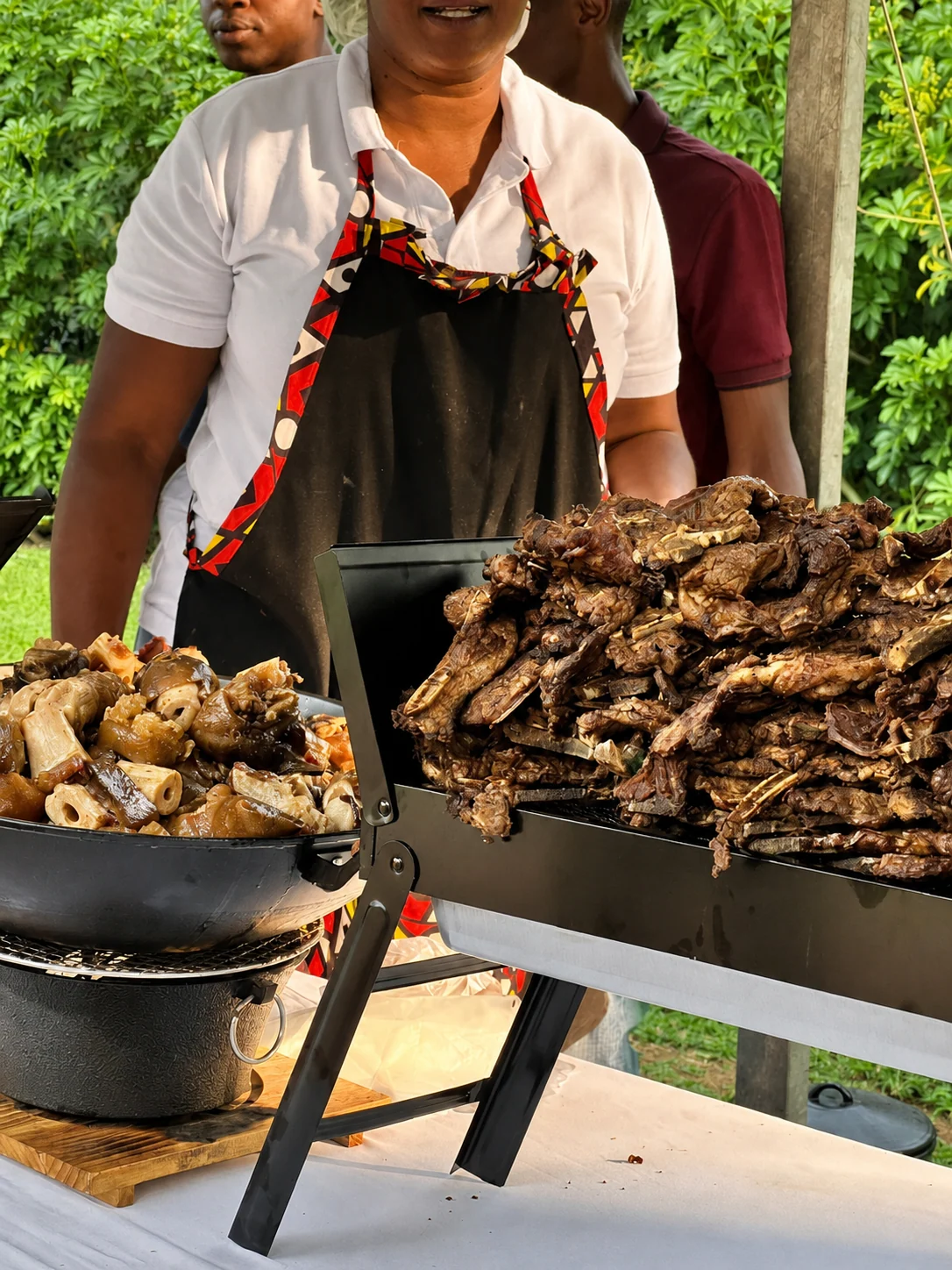 Rue's Manor Eats team serving grilled meat outdoors