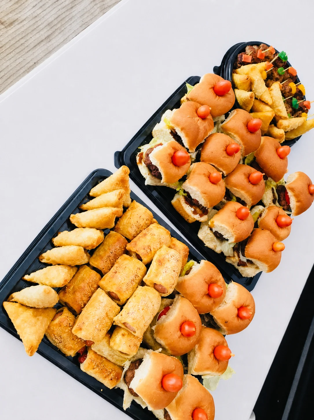 Platters of sliders, sausage rolls and savoury pastries